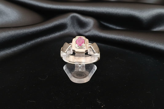Geometric Majesty: Oval-Cut Ruby & Multi-Faceted Silver Band